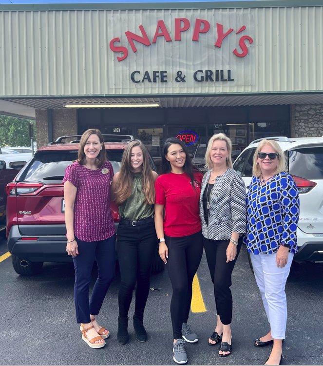 Stephanie Husmann, Emilee Paul, Anna Liu, Catherine Reilly and Lisa Kenny stand outside of Snappy’s as they prepare for a Saturday fundraising event. Liu is the owner of Snappy’s. Husmann, Paul, Reilly and Kenny are all with DMR Mortgage.